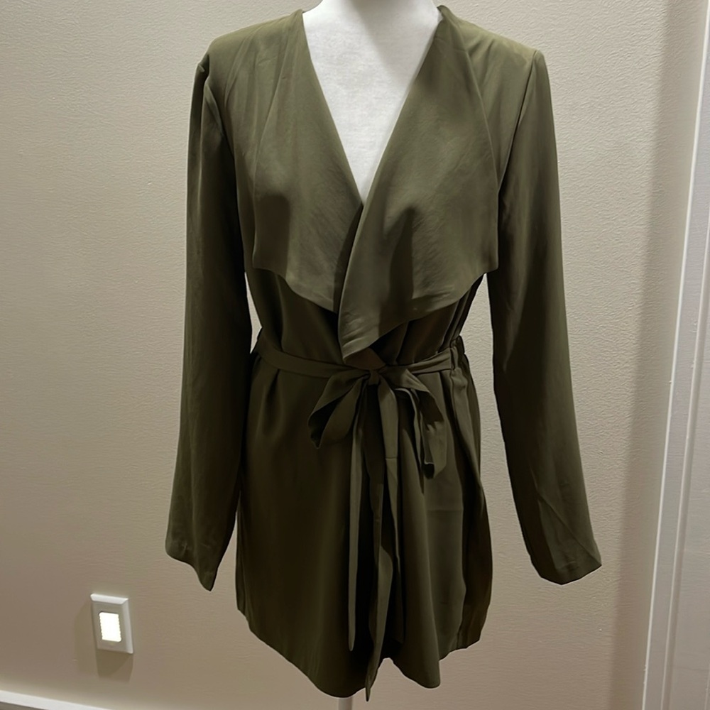 Olive green jacket. Not lined. Great with slacks or a dress. New w/out tags.